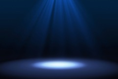 Blue spotlight on stage performance in a theater