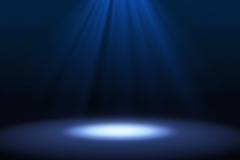 Blue spotlight on stage performance in a theater